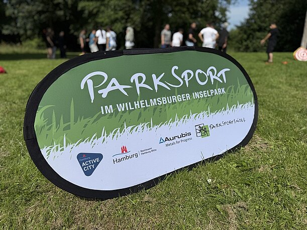 Banner „Parksport im Wilhelmsburger Inselpark“ auf der Wiese