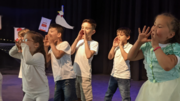 Vorschulkinder rufen gemeinsam auf der Bühne beim Theaterstück Flaschenpost