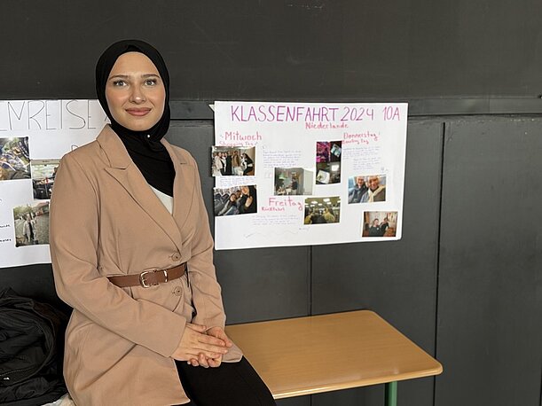Schülerin vor Plakat „Klassenfahrt 2024 10a“ bei der Profilpräsentation